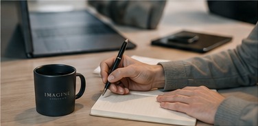 Consultant writing strategic notes during a client session